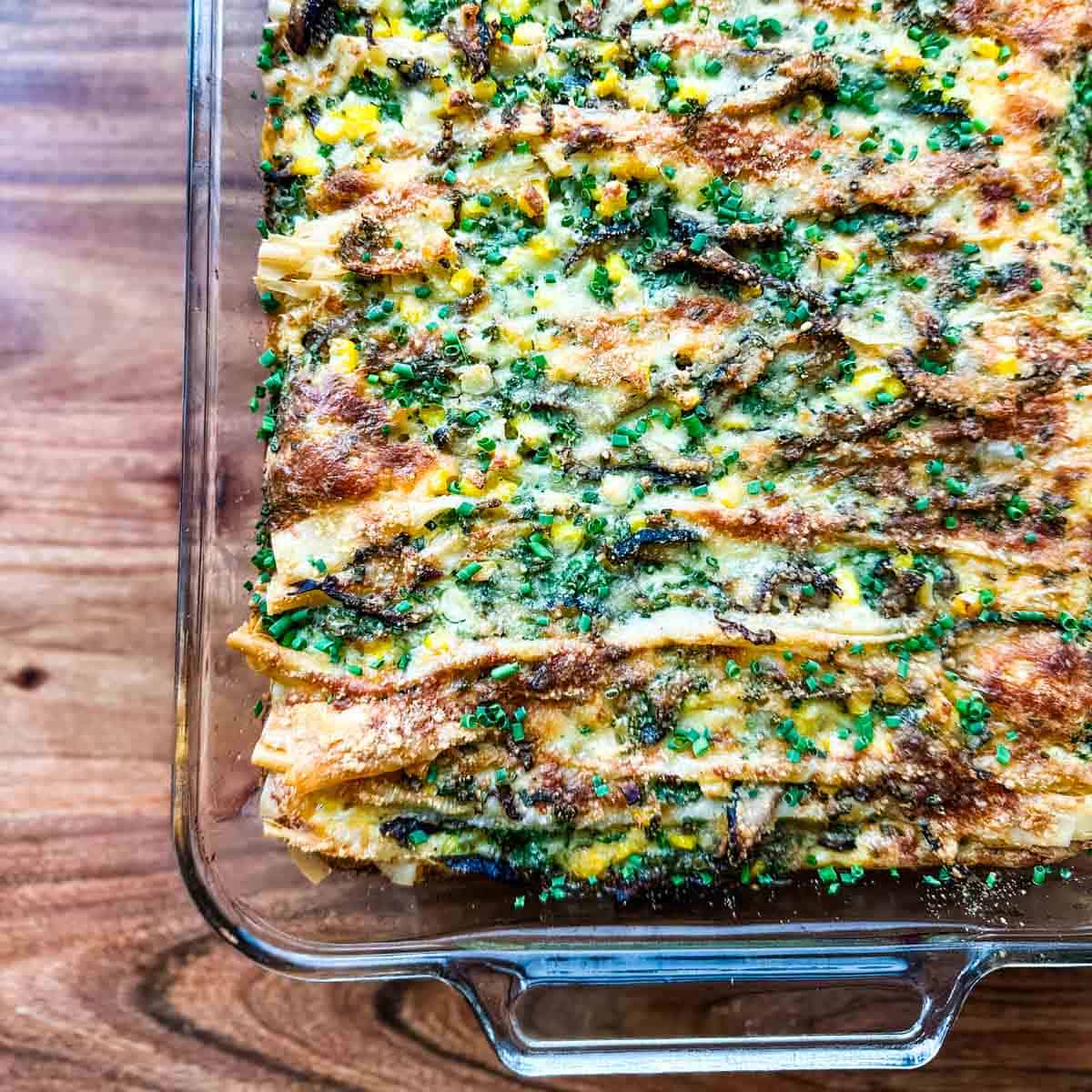 A glass pan of corn and shiitake phyllo crinkle tart on a cutting board.