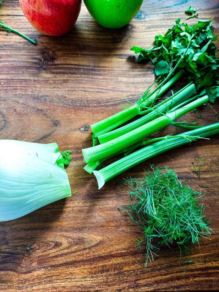 A fennel bulb on a cutting board with tops removed for apple fennel slaw.