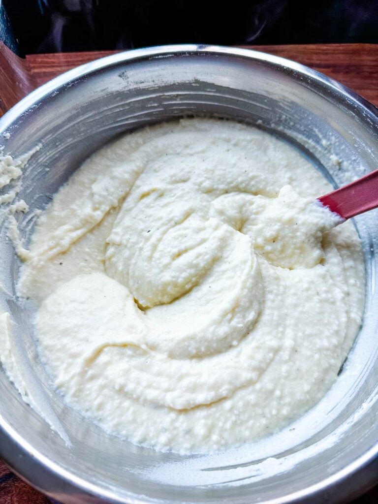 Boursin cheese and cream mixture fully incorporated into the riced potatoes.