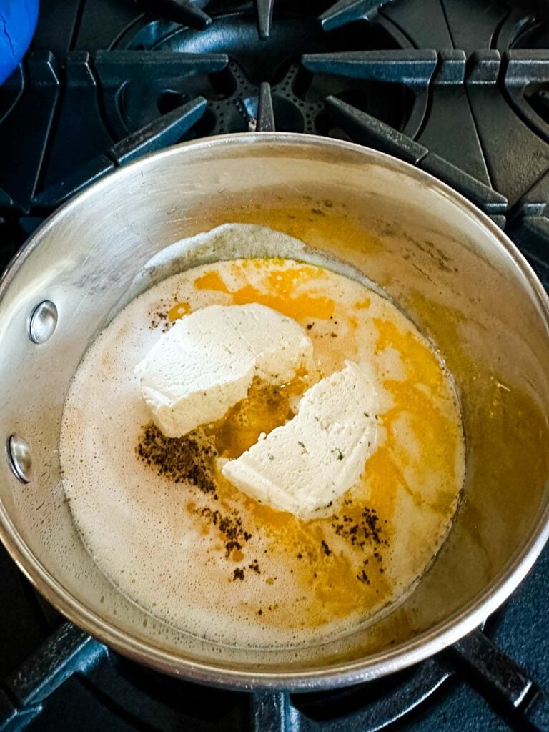 Boursin cheese in a saucepan with heavy cream, butter, salt and pepper.