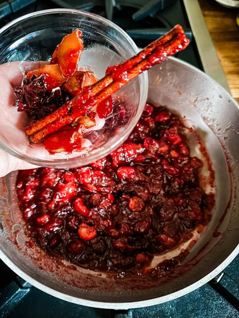 Spices being removed from cranberry sauce.