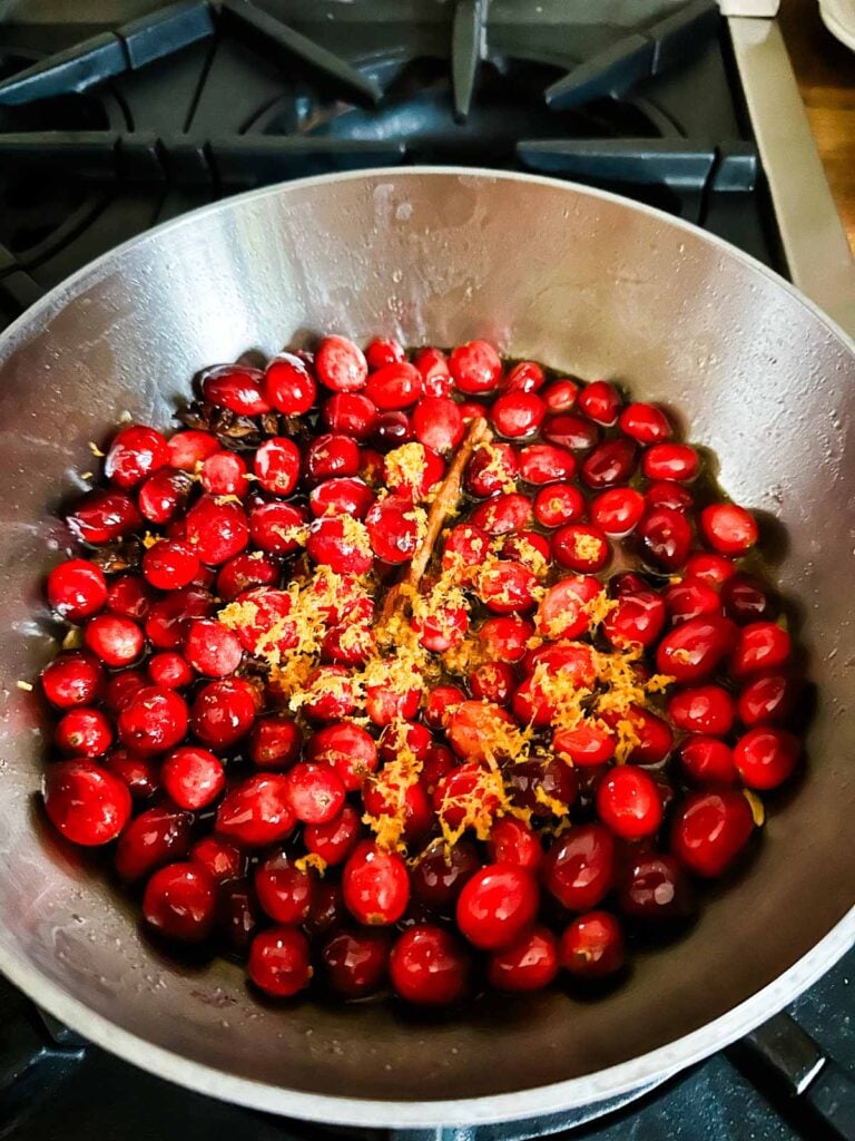 Orange zest added to cooking spiced cranberry sauce.