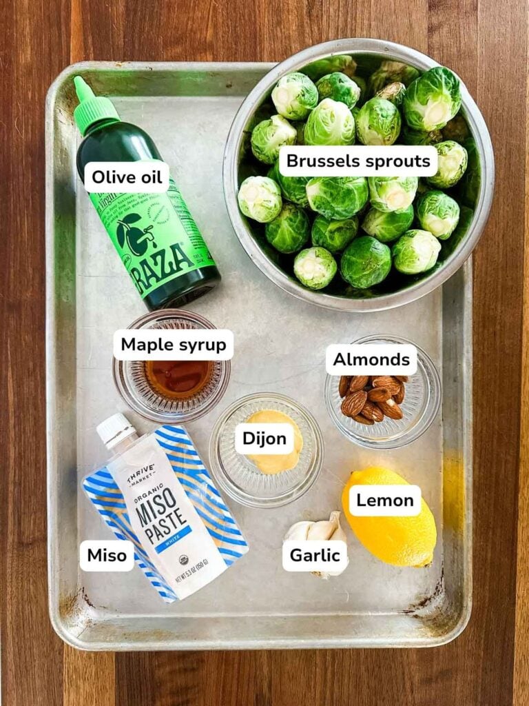 An overhead view of the ingredients necessary to make miso brussels sprouts on a sheet pan.