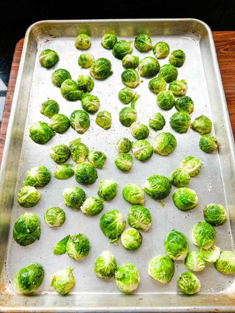 Brussels sprouts on a sheet pan, cut side down.